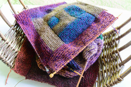 Close-up background image of a variegated knitted blanket with a colorful graphic design, crocheted,...