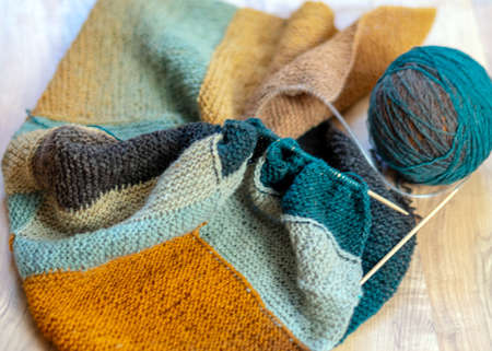 photography with colored knitting, needles and a ball of wool yarn, knitting as a hobby, handmade