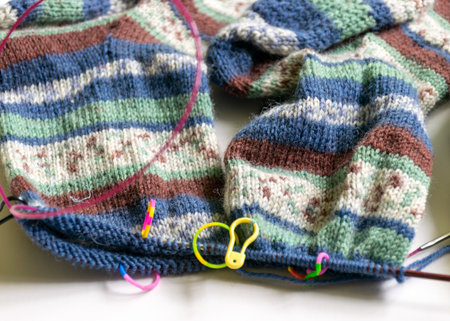 needlework, knitting socks, work in progress, photo with woolen yarn, knitting needles and half a...