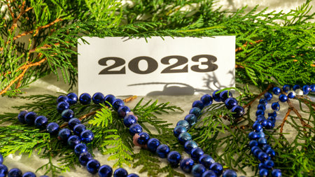 Christmas decorations, green needles, colorful ornaments, text 2023, Merry Christmas and Happy New Year!の写真素材