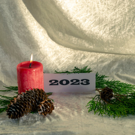 Christmas decorations on light background, red candle and text 2023, Happy New Year and Merry...
