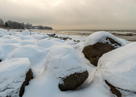 different ice formations on rocks on the seashore, ice texture, wind, water and ice working together, winter by the seaの写真素材