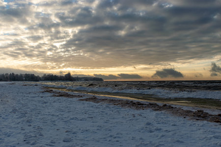 winter landscape, seashore, cloudy winter afternoon, snow and ice on the seashore, Baltic Sea coast, Latviaの写真素材