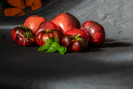 colorful, juicy, healthy tomatoes on a dark background, tasty and healthy nutrition, suitable for vegetariansの写真素材