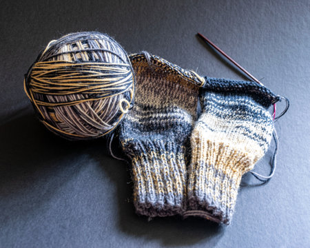 unfinished knitted work, cozy atmosphere, women's hobby knitting, the beginning of the sock knitting process, colorful yarn for knitting, Knitting conceptの写真素材