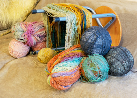 picture with yarn spools and balls of wool thread, skeins prepared for spooling, handicrafts,...