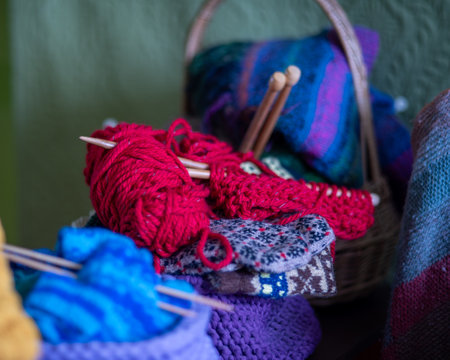 photo with unfinished knitted work, needlework concept, homemaker's work, knitting as a hobby, hobby as needleworkの写真素材