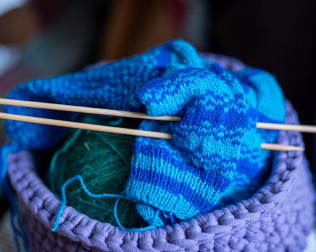 photo with unfinished knitted work, needlework concept, homemaker's work, knitting as a hobby, hobby as needleworkの写真素材