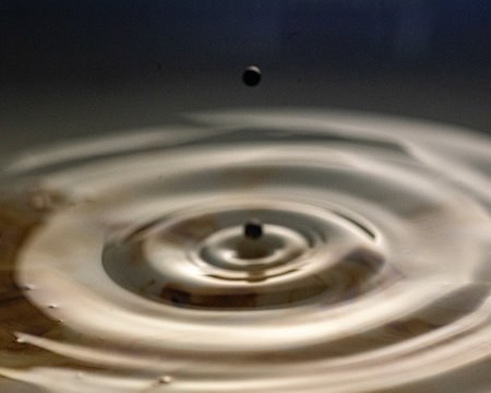 abstract picture with colored drop of various shapes, blurred background, water drop splash, close focus, grainy water textureの写真素材