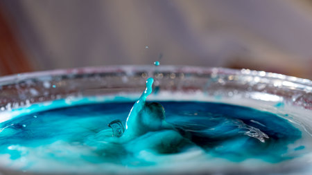 abstract picture with colored drop of various shapes, blurred background, water drop splash, close focus, grainy water textureの写真素材