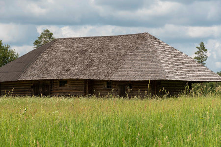 rural landscape with beautiful clouds and old wooden barn, summerの写真素材