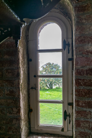 ancient window, stone building, view through the window, summerの写真素材