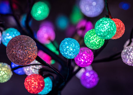 colorful Christmas decoration balls on the windowsill, reflections on the window glass, holiday decorationsの写真素材