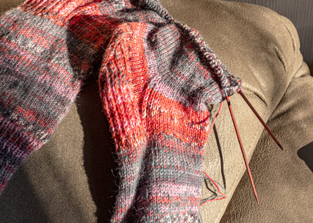 colorful knitted work in progress, handicraft concept, knit texture, wool handicrafts, hobby, winter activitiesの写真素材