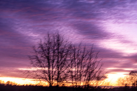 colorful sunrise sky outside the window, colorful play of light, shadows and reflections on the window glass, blurred outlines, winterの写真素材