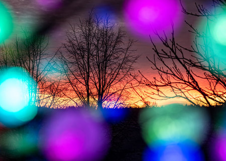 outside the window colorful sunrise sky, colorful play of light, shadows and reflections on the window glass, explosion of colors, winterの写真素材