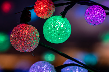 colorful Christmas decoration balls on the windowsill, reflections on the window glass, holiday decorationsの写真素材