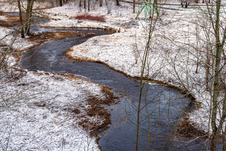 landscape with wild wild river, blurred water, snow on the river banks, winterの写真素材