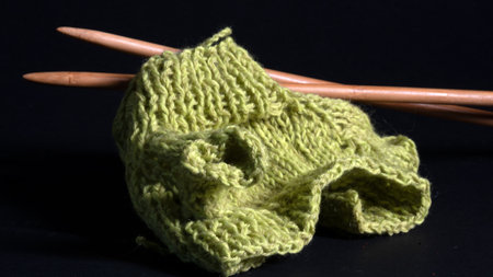close-up of unfinished knitting, woolen threads and needles, handmade, home-made concept