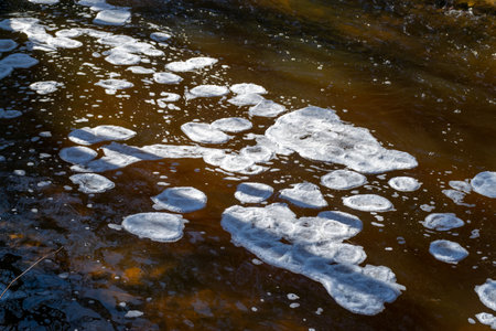 ice formations in a wild river, beautiful frozen ice formations from the interaction of water, flow and frost, Raunis, Latvia, springの写真素材