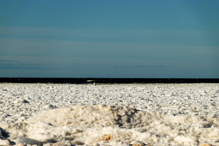 winter landscape by the sea, pieces of different sizes, sea horizon in the distance, blue sky, winterの写真素材