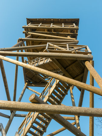 sunny spring landscape with a wooden observation tower against the sky, early springの写真素材
