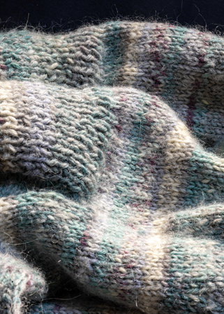 knitted socks made of wool yarn, handicraft concept, knit texture