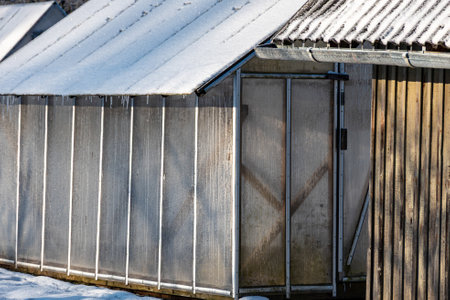 wonderful winter day, trees and grass covered with frost, film greenhouse in the garden, winterの写真素材