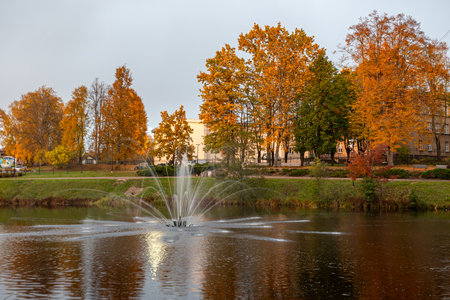 landscape with a fountain in the city park, bright colors, city park in the evening, Valmiera, Latviaの写真素材