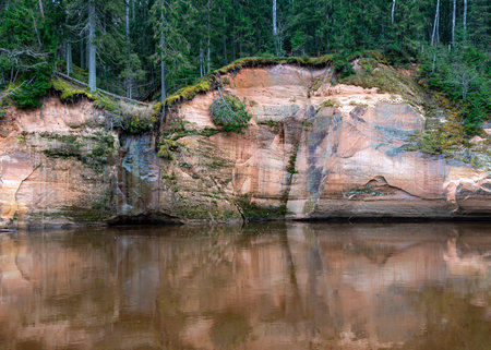 beautiful view of sandstone outcrops on the riverbank, autumn landscape, reflections in the riverの写真素材