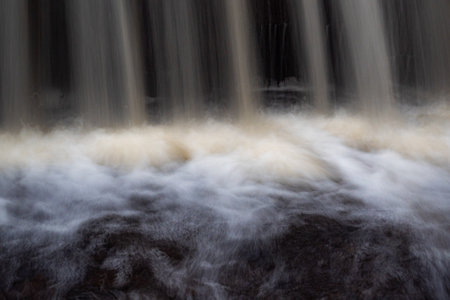 a long exposure view of a small fast river, beautiful water formations, autumn landscape, november in nature, Ieriku mill, Melderupe, Latvia, fallの写真素材