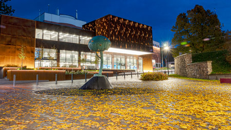 beautiful evening landscape, city view in autumn, illuminated streets and houses, reflections and bright colors, Valmiera, Latviaの写真素材