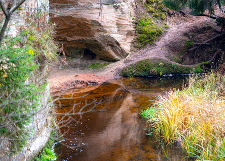 beautiful view of sandstone outcrops on the riverbank, autumn landscape, reflections in the riverの写真素材