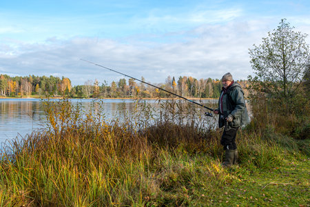 landscape with an angler on the bank of a river or lake, fishing concept, leisure entertainment,...