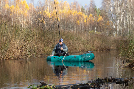fisherman catches fish from a boat in a river, lake, fishing concept, free time entertainment,...