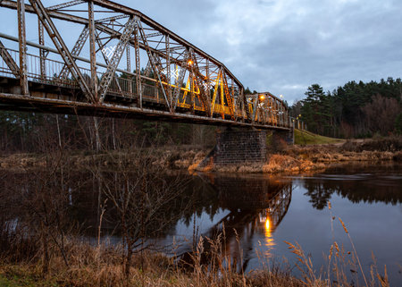 iron structures, old railway bridge decorated in bright colors, night landscapeの写真素材