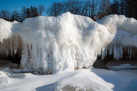 Wonderful view of the frozen sea coast in winter, pieces of ice of different sizes, ice-covered...