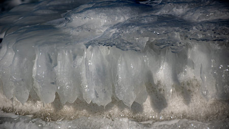 Wonderful view of the frozen sea coast in winter, pieces of ice of different sizes, ice-covered...
