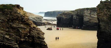 Cathedrals Beach's abrupt cliffs see people walking through themの写真素材
