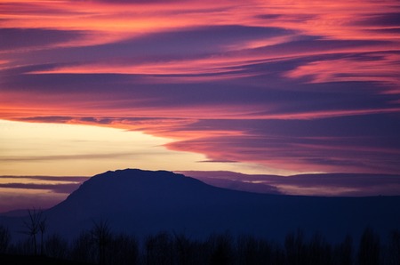 Orange and purple fluffy clouds at sunset over Etxauri s peak at Navarra, Spainの写真素材