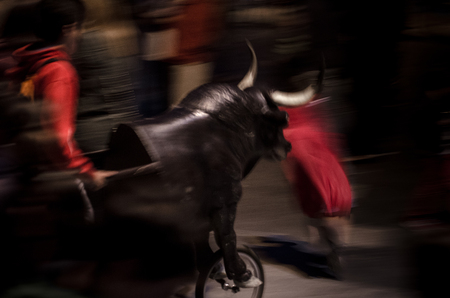 Typical fake bull with a wheel that pursues kids in spanish village festivalsの写真素材