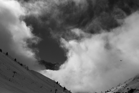 Cloudy sky, a bird and mountain sky slopesの写真素材