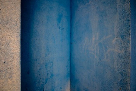 Blue walls full of spots, graphitty letters and other dirt pieces in Pamplona, Spainの写真素材