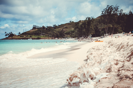 One of the multiple white sand beaches from Hawaii, with characteristic greeen vegetation backgroundの写真素材
