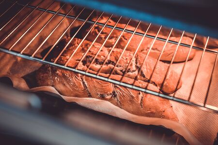 Artisanal baguettes into the ovenの写真素材