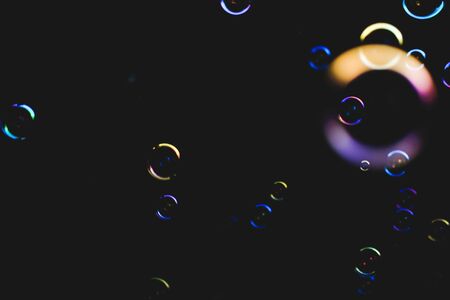 Colorful bubbles over dark backgroundの写真素材