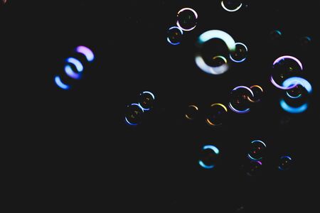 Colorful bubbles over dark backgroundの写真素材