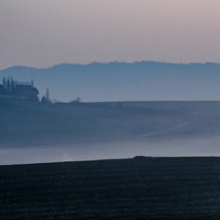 Dark to light blue in 3 layers of fields and the sky before the sunrise in Mutilva, Spainの写真素材