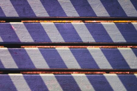 Lights and shadows pattern on a park seat in San Sebastian, Spainの写真素材
