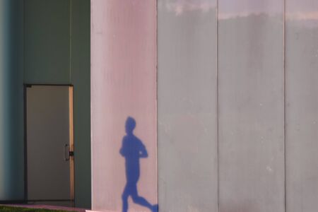 Peoples shadow projected on the glass walls of the bus station of Pamplona, Spainの写真素材
